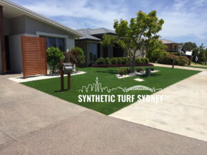 Modern home with lush synthetic turf lawn and minimal landscaping.