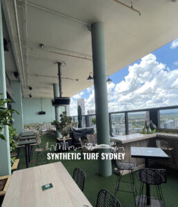 Outdoor rooftop dining area with city views at Synthetic Turf Sydney.