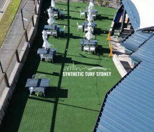 A rooftop with multiple white synthetic turf machines lined up.