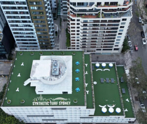 Aerial view of rooftops and streets in an urban area.